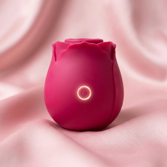 Stimulateur clitoridien Luxxox La Rose en forme de bouton de rose, coloris rose fushia sur fond rose